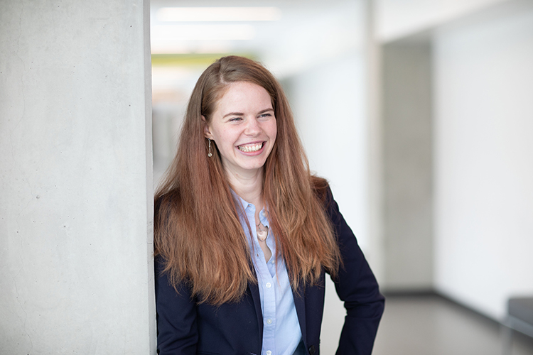 NAIT emergency bursary recipient Willow Shelley standing in the NAIT Centre for Applied Technology building.