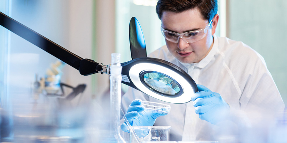 Researchers in lab analyzing water samples.