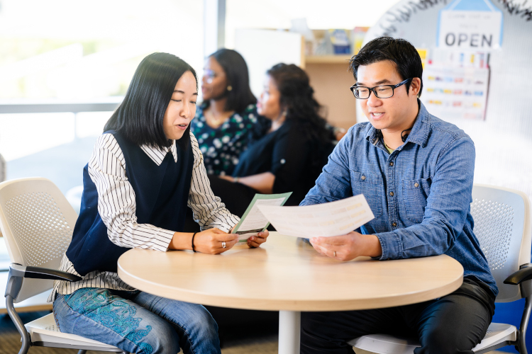 two students working on a project at a table at NAIT