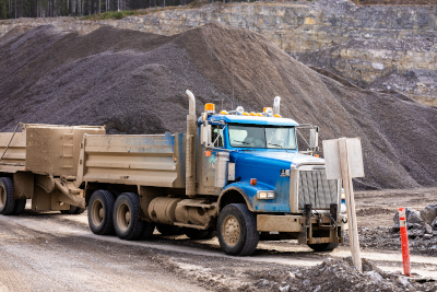 A truck on a mining work site with two loads