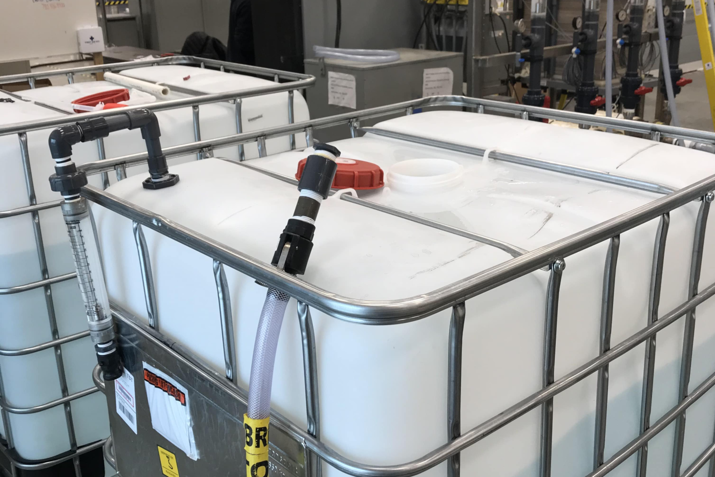 A man and a woman with a clipboard are looking at NAIT Applied Research's microgrid 