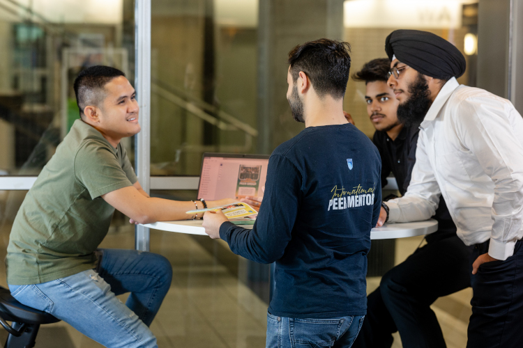 four software students work on agile planning on the NAIT campus