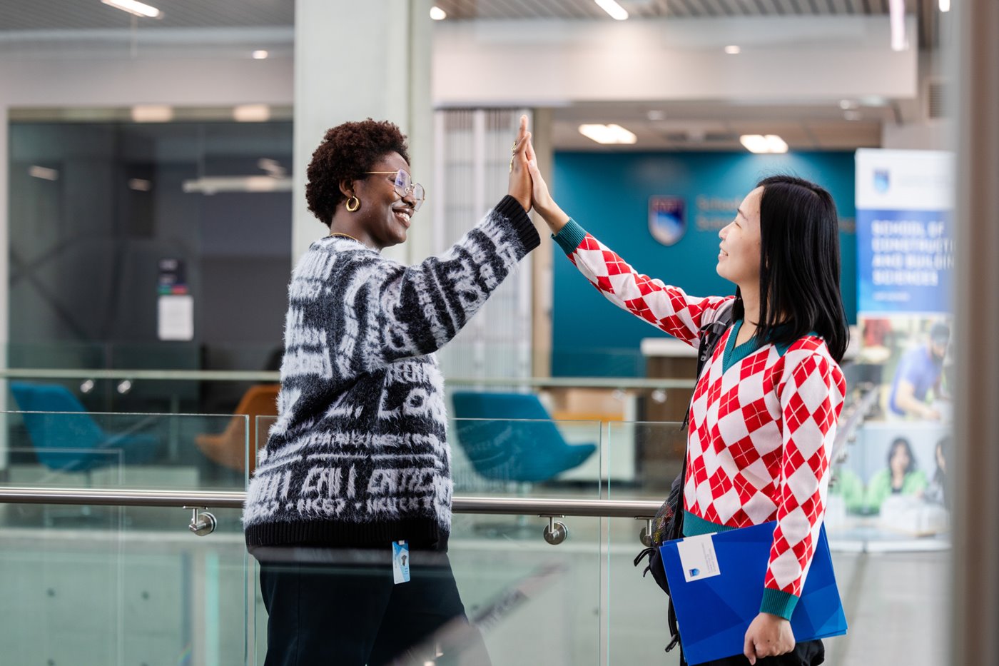 two women giving a high five