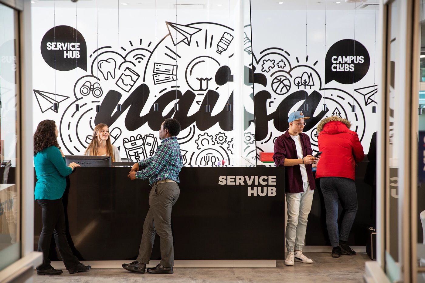 students standing and talking at naitsa office