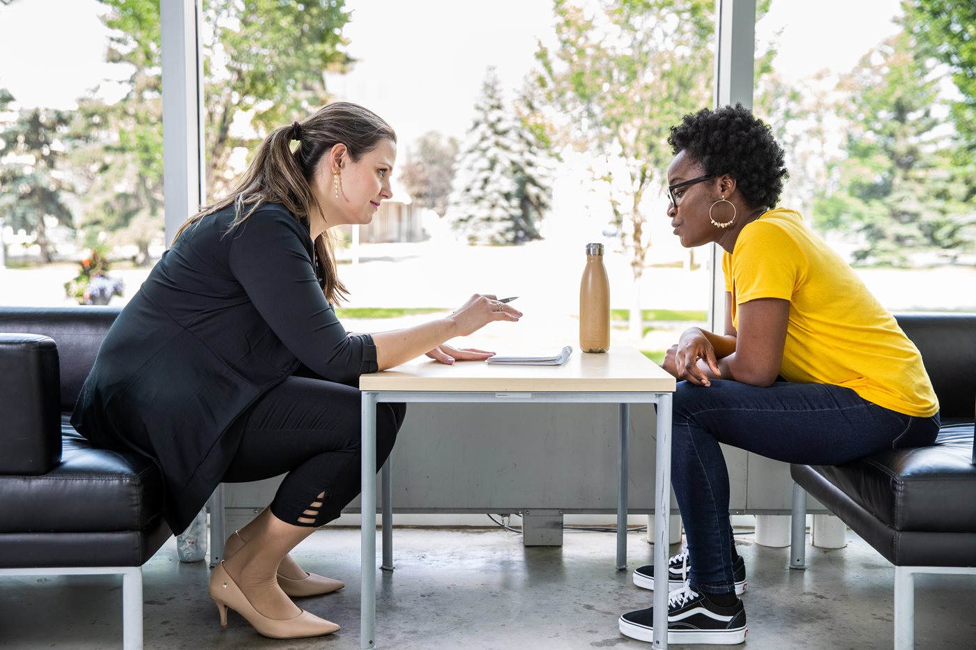 Student being assisted by a NAIT advisor on campus