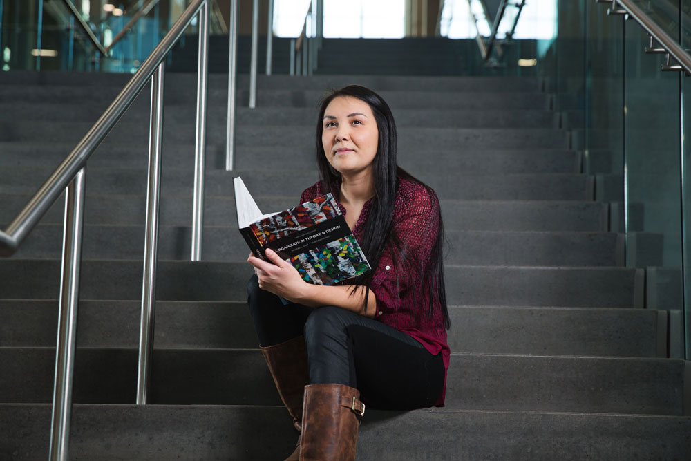 Student sitting on stairs in the Feltham Centre