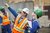Man in a hard hat pointing while a woman watches