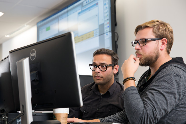 Two finance students on the NAIT campus
