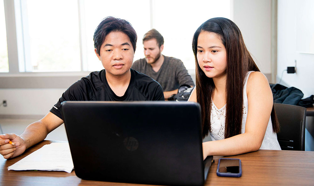 students working on laptop at NAIT
