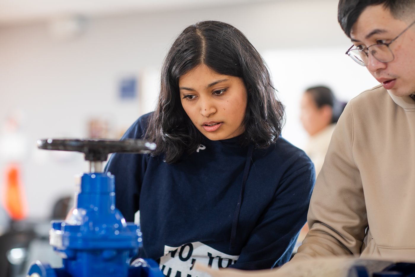 Female student takes notes on engineering design